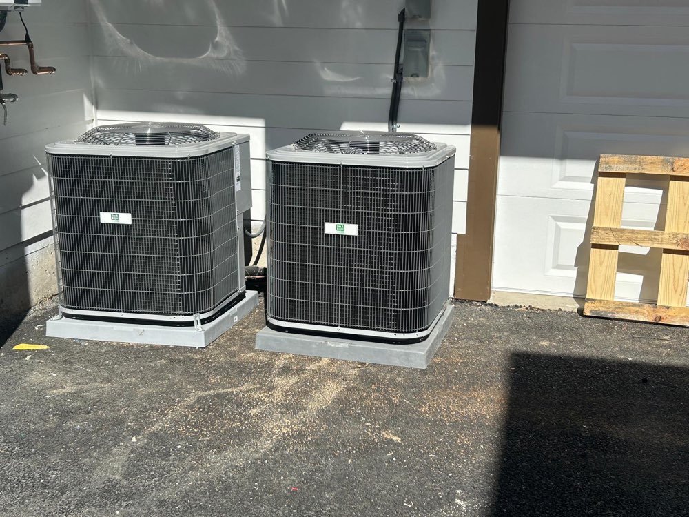 Two outdoor air-conditioning units side by side on individual bases.